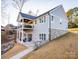 Gray two-story home with stone accents, deck, and walkway at 7476 Point St, Denver, NC 28037