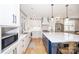 Modern kitchen with white cabinets, a large island, and stainless steel appliances at 7476 Point St, Denver, NC 28037