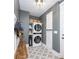 Convenient laundry room with stackable washer/dryer, bench, and storage at 7476 Point St, Denver, NC 28037