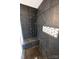 Modern shower with marble tile and built-in seat at 7476 Point St, Denver, NC 28037