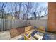 Small, fenced backyard with patio furniture and a sitting area at 8465 Ramath Dr, Charlotte, NC 28211