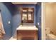 Clean bathroom with a dark vanity and a medicine cabinet at 8465 Ramath Dr, Charlotte, NC 28211