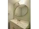 Updated bathroom with a round mirror and modern vanity at 8465 Ramath Dr, Charlotte, NC 28211