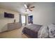 Spacious bedroom with a dresser, large bed, and ceiling fan at 8465 Ramath Dr, Charlotte, NC 28211