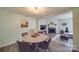 Bright dining area with round table and four chairs, open to living room at 8465 Ramath Dr, Charlotte, NC 28211