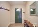 Inviting entryway with dark green door, coat rack, and shoe storage at 8465 Ramath Dr, Charlotte, NC 28211