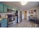 Modern kitchen with teal cabinets, stainless steel appliances, and white backsplash at 8465 Ramath Dr, Charlotte, NC 28211