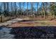 Backyard with wooden fence, partially covered with leaves and mulch at 940 Valley Dr, Newton, NC 28658