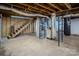 Unfinished basement with wooden stairs and HVAC system at 940 Valley Dr, Newton, NC 28658