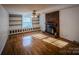 Living room with hardwood floors, built-in shelves, and fireplace at 940 Valley Dr, Newton, NC 28658