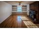 Living room with hardwood floors, built-in shelves, and fireplace at 940 Valley Dr, Newton, NC 28658