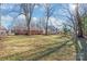 Spacious backyard with large grassy area and mature trees at 941 Squirrel Hill Rd, Charlotte, NC 28213