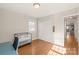 Bright bedroom with hardwood floors and access to hallway at 941 Squirrel Hill Rd, Charlotte, NC 28213