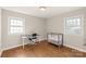 Versatile bedroom with hardwood floors, crib, and workspace at 941 Squirrel Hill Rd, Charlotte, NC 28213