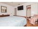 Main bedroom with a wooden sleigh bed, light blue bedding, and a large TV at 9938 Sandra Ln, Fort Mill, SC 29707