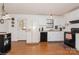 Bright kitchen features white cabinets, modern appliances, and wood-look floors at 9938 Sandra Ln, Fort Mill, SC 29707