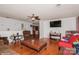 Living room with hardwood floors, comfy seating, and a large TV at 9938 Sandra Ln, Fort Mill, SC 29707