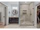 Bathroom with walk-in shower, vanity, and built-in shelves at 102 Serene St, Mount Gilead, NC 27306