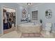 Bathroom with corner soaking tub and walk-in closet at 102 Serene St, Mount Gilead, NC 27306
