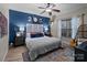 Spacious bedroom with a ceiling fan, large bed, and a blue accent wall at 102 Serene St, Mount Gilead, NC 27306