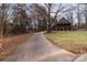 Long driveway leading to a charming house nestled in the woods at 102 Serene St, Mount Gilead, NC 27306