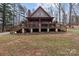 A-frame home with a deck, stone accents, and wooded surroundings at 102 Serene St, Mount Gilead, NC 27306