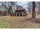 A-frame style house exterior with a wrap-around deck and landscaped yard at 102 Serene St, Mount Gilead, NC 27306