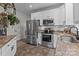 Modern kitchen with stainless steel appliances and granite countertops at 102 Serene St, Mount Gilead, NC 27306