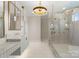 Bright bathroom featuring double vanity, chandelier lighting, and frameless glass shower at 1108 Ardsley Rd, Charlotte, NC 28207