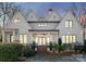 Charming white brick home featuring a welcoming front porch, manicured landscaping, and a classic architectural design at 1108 Ardsley Rd, Charlotte, NC 28207