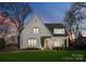 Charming brick home featuring manicured landscaping, wooden door, and a welcoming covered front porch at 1108 Ardsley Rd, Charlotte, NC 28207