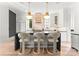 Modern kitchen with a large island, sleek countertops, bar seating, and contemporary pendant lighting at 1108 Ardsley Rd, Charlotte, NC 28207