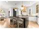 A spacious kitchen featuring a large center island, modern light fixtures, and white cabinets at 1108 Ardsley Rd, Charlotte, NC 28207