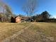 Two brick houses on a large lot with a swing set at 114 Barker Rd, Dallas, NC 28034