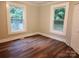 Bedroom with two windows, light walls, and wood-look floors at 1302 Brookdale St, Kannapolis, NC 28083