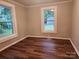 Second bedroom with wood-look floors and two windows at 1302 Brookdale St, Kannapolis, NC 28083
