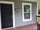 Black front door with white trim, and a mailbox on the porch at 1302 Brookdale St, Kannapolis, NC 28083