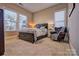 Comfortable bedroom with a double bed, nightstand, and a leather armchair at 13204 Feale Ct, Charlotte, NC 28278