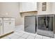 Bright laundry room, featuring washer, dryer, and built-in cabinets at 13204 Feale Ct, Charlotte, NC 28278