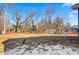 Spacious backyard with mature trees and partial snow cover at 1455 Southwest Blvd, Newton, NC 28658