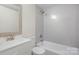 Updated bathroom with grey tile and a white vanity at 1464 Bradford Heights Rd, Gastonia, NC 28054