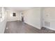 Spacious living room featuring light walls and grey flooring at 1464 Bradford Heights Rd, Gastonia, NC 28054