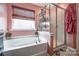 Bathroom with soaking tub, walk-in shower and pink walls at 17114 Belmont Stakes Ln, Charlotte, NC 28278