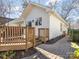 Inviting backyard with wooden deck, manicured landscaping, and brick pathway offering seamless outdoor living at 1716 Truman Rd, Charlotte, NC 28205