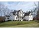 Two story home with white brick and taupe accents, front porch, and landscaped yard at 2010 Belle Grove Dr, Marvin, NC 28173