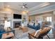 Cozy living room features leather sofas, a fireplace, and built-in shelving at 2010 Belle Grove Dr, Marvin, NC 28173