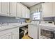 Bright laundry room with washer, dryer, and ample cabinet space at 2087 Yellowstone Dr, Fort Mill, SC 29707