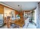 Sunlit dining room, featuring a large wooden table and access to another room at 2808 Water Plant Rd, Maiden, NC 28650