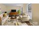 Bright living room featuring stylish furniture, area rug, and a modern entertainment center at 3 Old Farm Rd, Salisbury, NC 28147