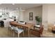 Open-concept dining area with a wood table, comfortable chairs, and a view of the kitchen at 309 Old Town Village Rd, Waxhaw, NC 28173